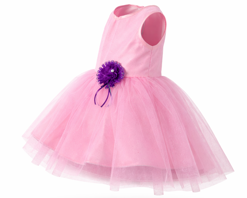 Pink dress with a purple flower accessory on a white background